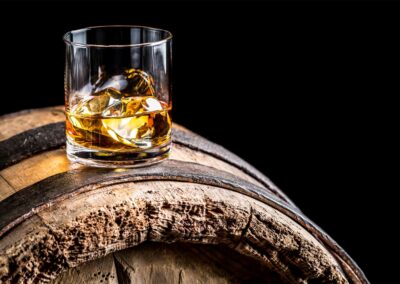 Glass Whisky on wooden barrel