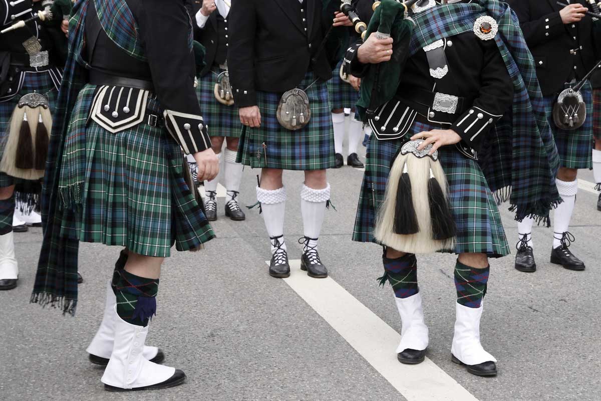 A Scottish pipe band prepare to play. Used on the Isle of Skye vacations page of the Turas Travel website.